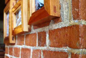 Closeup a wooden picture frame on the brick wall 