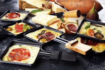 Delicious traditional Swiss melted raclette cheese on diced boiled or baked potato.