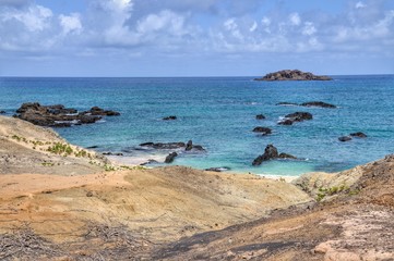 Fototapeta na wymiar Volcanic rocks lay on the beachfront of Djeu in the archipelago of Cabo Verde