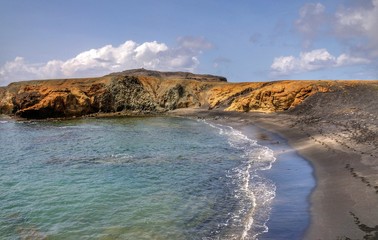 Fototapeta na wymiar Bay with a black sand beach in Djeu, Cabo Verde