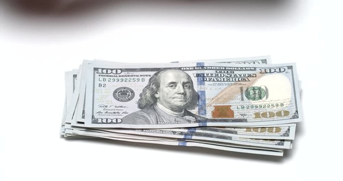 Person counting one hundred dollar banknotes, cash salary, timelapse