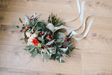 Beautiful wedding flowers with red and white roses and long silk ribbons