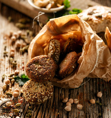 Homemade chickpea falafels in a paper bag on a wooden table, close-up