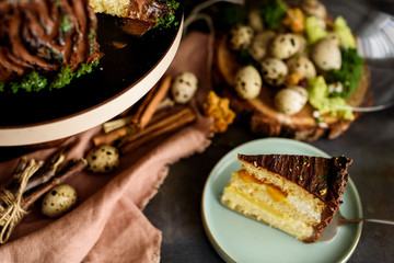 Delicious cake in the cut, a piece of cake with a layer of mango, passion fruit, vanilla cream, biscuit, eggs, flat lay.