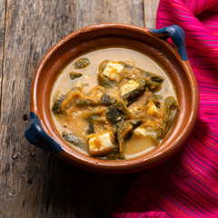 Mexican poblano pepper rajas and panela cheese on wooden background