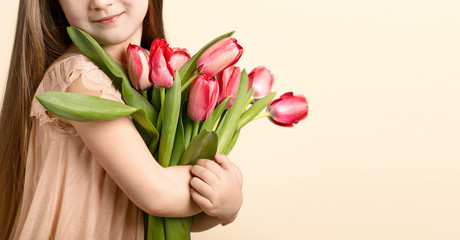Picture of litlle girl with tulips in hands