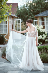 Fototapeta premium Beautiful bride. Woman waving dress. Sexy girl with professional make up