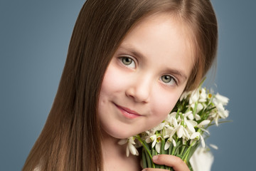 Picture of litlle girl with snowdrops in hands