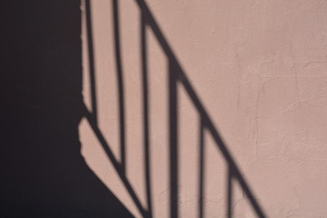 railing reflection on brown wall, background