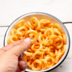 Rings of fried wheat with piquant sauce is a mexican snack on white background