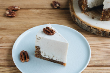  cake with cream. Pecan cake on a wooden background. Raw dessert. Food photography