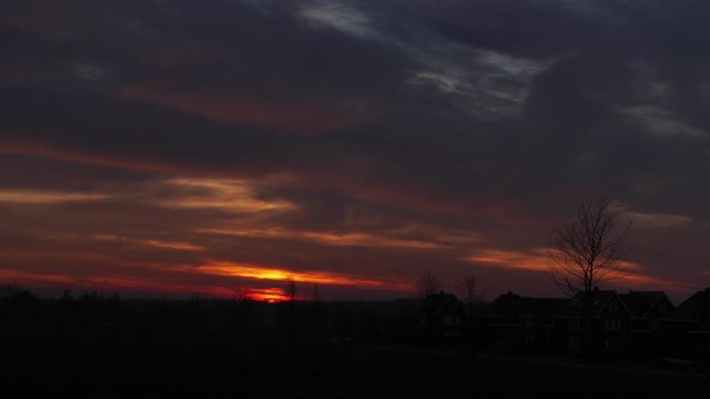 Timelapse of the sunset and the clouds coloring the deep red