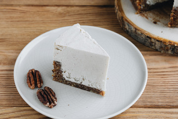  cake with cream. Pecan cake on a wooden background. Raw dessert. Food photography