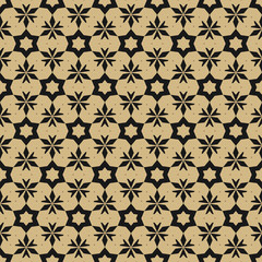 Vector golden floral seamless pattern. Elegant gold and black Christmas background. Luxury geometric texture with small flowers, stars, leaves, triangles. Festive holiday ornament. Repeatable design