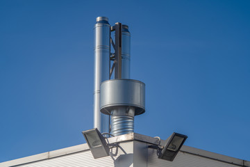 shiny metal ventilation pipes blue sky background