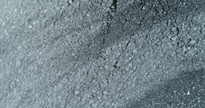 Cracked Ice floes on the dark water surface. Filmed from above.