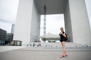 Fototapeta premium Travel bag is her companion. Sexy woman travel in modern city. Leisure and pleasure travel. Traveling and wanderlust. Go sightseeing around city. Summer vacation. Book travel