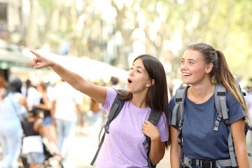 Backpackers sightseeing in the street finding landmark