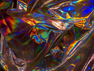 Holographic iridescent foil texture background. Futuristic vibrant neon trendy mermaid silver colors