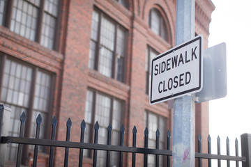 Sidewalk closed sign in downtown