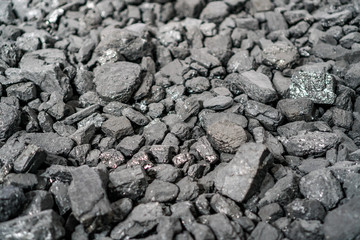 Char-coal. Pattern, heap. Pile of Bituminous Coal cinder. Stone coal Industry, business. Black coal mine close-up with soft focus. Anthracite coal bar