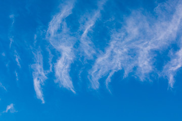 Clouds (cirrus and strata) over blue sky.