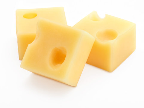 Portions (cubes, dice) of Emmental Swiss cheese. Texture of holes and alveoli. Isolated on white background