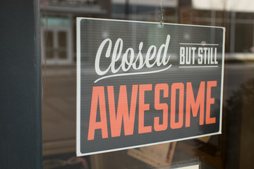 Closed but still awesome sign hanging in business window