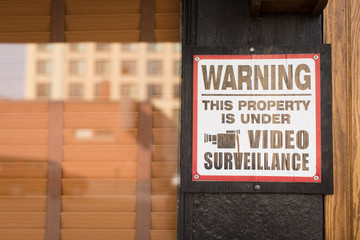 Property under video surveillance sign on business