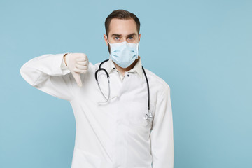 Male doctor man in white medical gown sterile face mask gloves isolated on blue wall background....