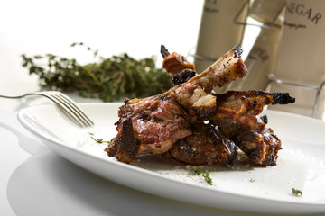 Appetizing grilled ribs isolated on white background. Grilled veal ribs
