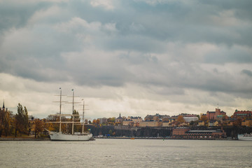 Hostel ship or sailboat of Af Chapman in Stockholm in front of Katarina - Sofia area in the background on a cloudy rainy autumn day.