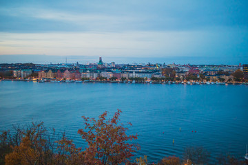 Naklejka premium Beautiful landscape photo of Stockholm cityscape viewed from Skinnarviksberget on early evening in autumn. Beautiful Stockholm evening panorama from famous vantage point.