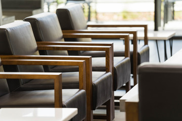 detail of lounge leather and wood chairs