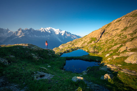From above small tent and clear lake reflecting sky high in mountains in sunny day in Chamonix, Mont-Blanc