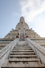 Central Spire at the Wat Arun buddhist temple in Bangkok, Thailand on a sunny day