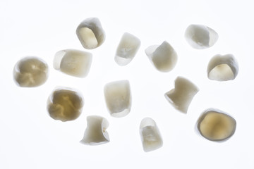 Fototapeta na wymiar beautiful composition of dental crowns and veneers on a white background with clearance