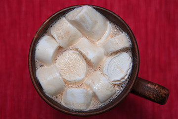 Marshmallows with cocoa in a brown clay cup