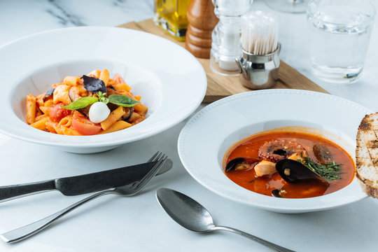 From above of seafood spicy soup and hot paste with tomatoes on table in restaurant 