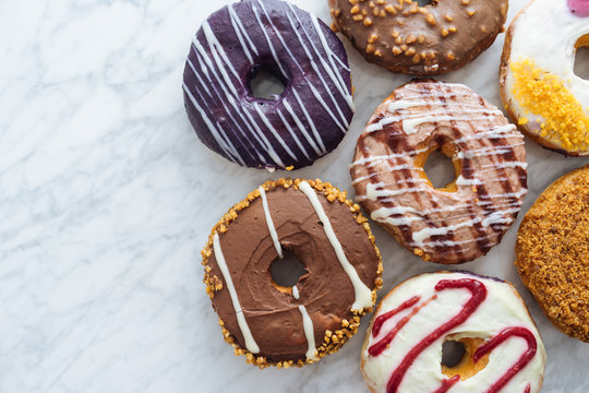 Variety of doughnuts on marble background