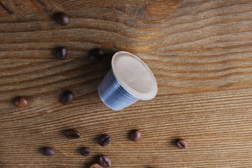 capsules of coffee on a wooden background