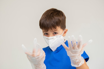 Caucasian boy wearing mask and surgical gloves with gesturing with his hands protecting himself from respiratory diseases. Face mask to protect against outbreaks of coronavirus, covid-19, virus, disea