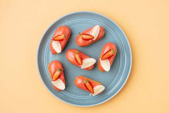 Strawberry eclairs with white chocolate leaves