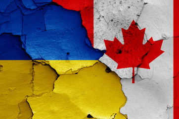 flags of Ukraine and Canada painted on cracked wall
