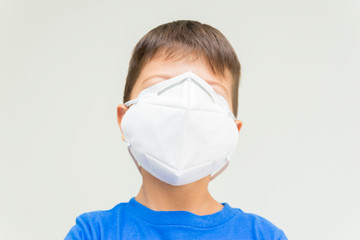 Caucasian boy with surgical mask covering his face. Face mask for protection against coronavirus outbreaks. Face mask against: virus, disease, epidemic, flu. COVID-19.