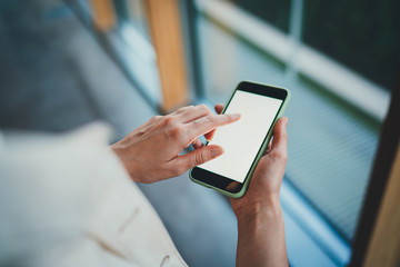 Back viev photo of young businesswoman using modern smartphone with blank screen for text message or design, mock up of cellphone device, Business People Technology Communication Internet Object