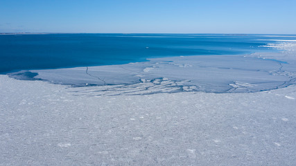 Huge ice floes on the sea. Ice drift. View from the top with a drone. Background. Scenery. Gulf of Finland.