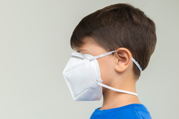 Caucasian boy with surgical mask covering his face. Face mask for protection against coronavirus outbreaks. Face mask against: virus, disease, epidemic, flu. COVID-19.