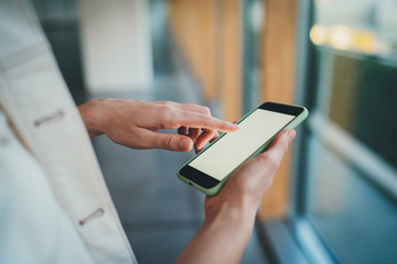 Closeup of female hands using smartphone indoor with a touch screen copy space for your text message or design, Technology Object Online Communication