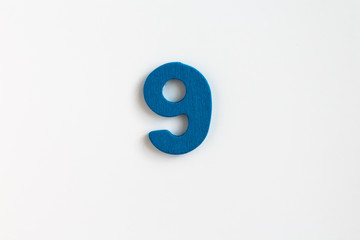 blue painted wooden number nine, craft sign for kid's education isolated, ecological concept